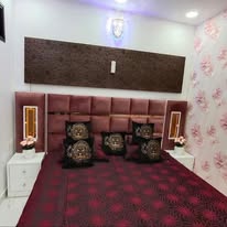 Styled bedroom in burgundy with a tufted headboard
