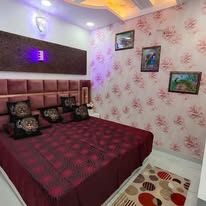Styled burgundy bedroom, alternate angle