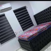 Zebra blinds paired with a styled bed