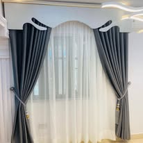 Arched curtain pelmet with sheer drapes