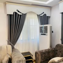 Curtain valance styling with tufted sofas
