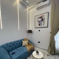 Living room styling detail with wall art and floor lamp