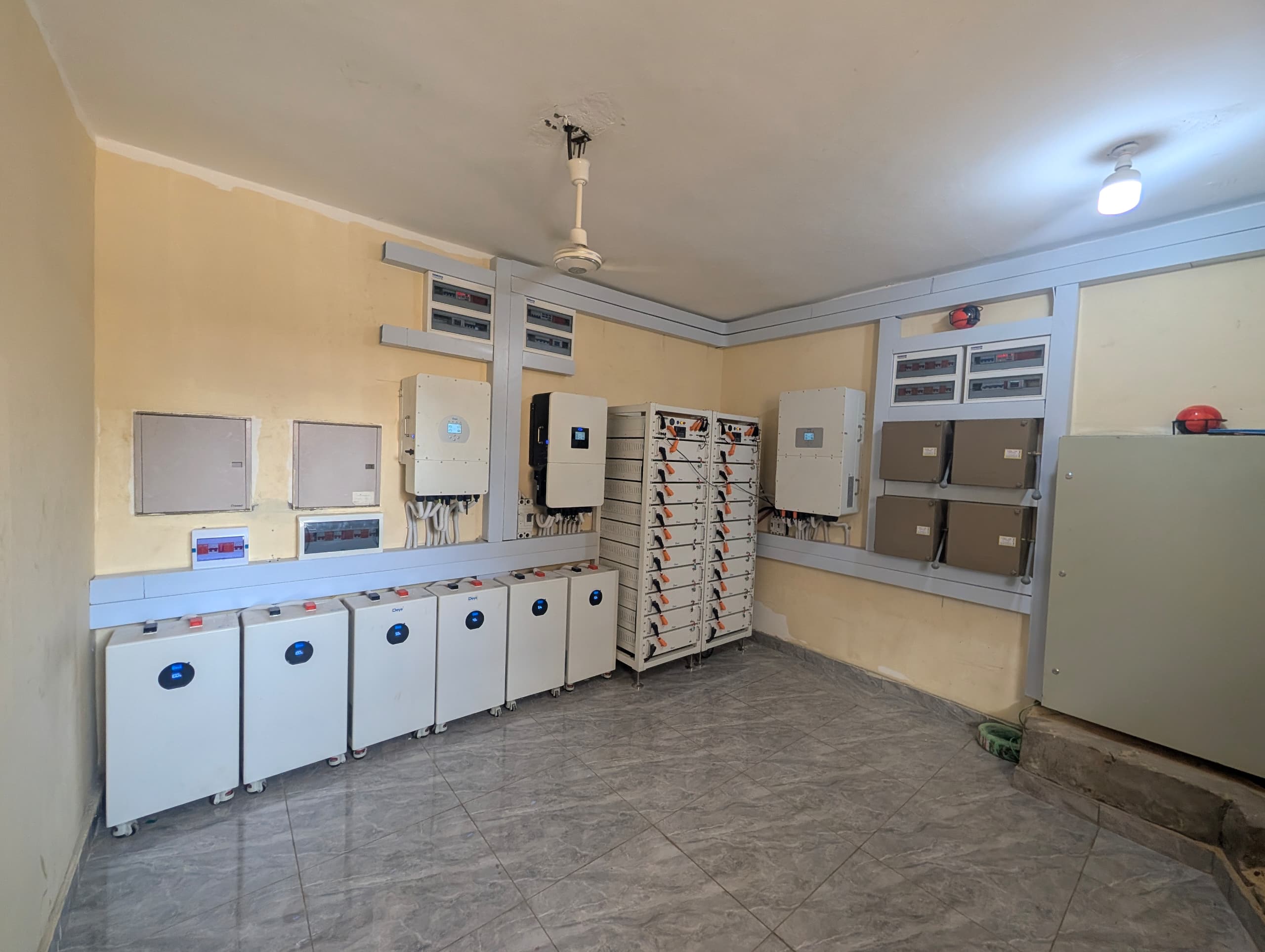A fully equipped solar plant room with inverters and battery banks
